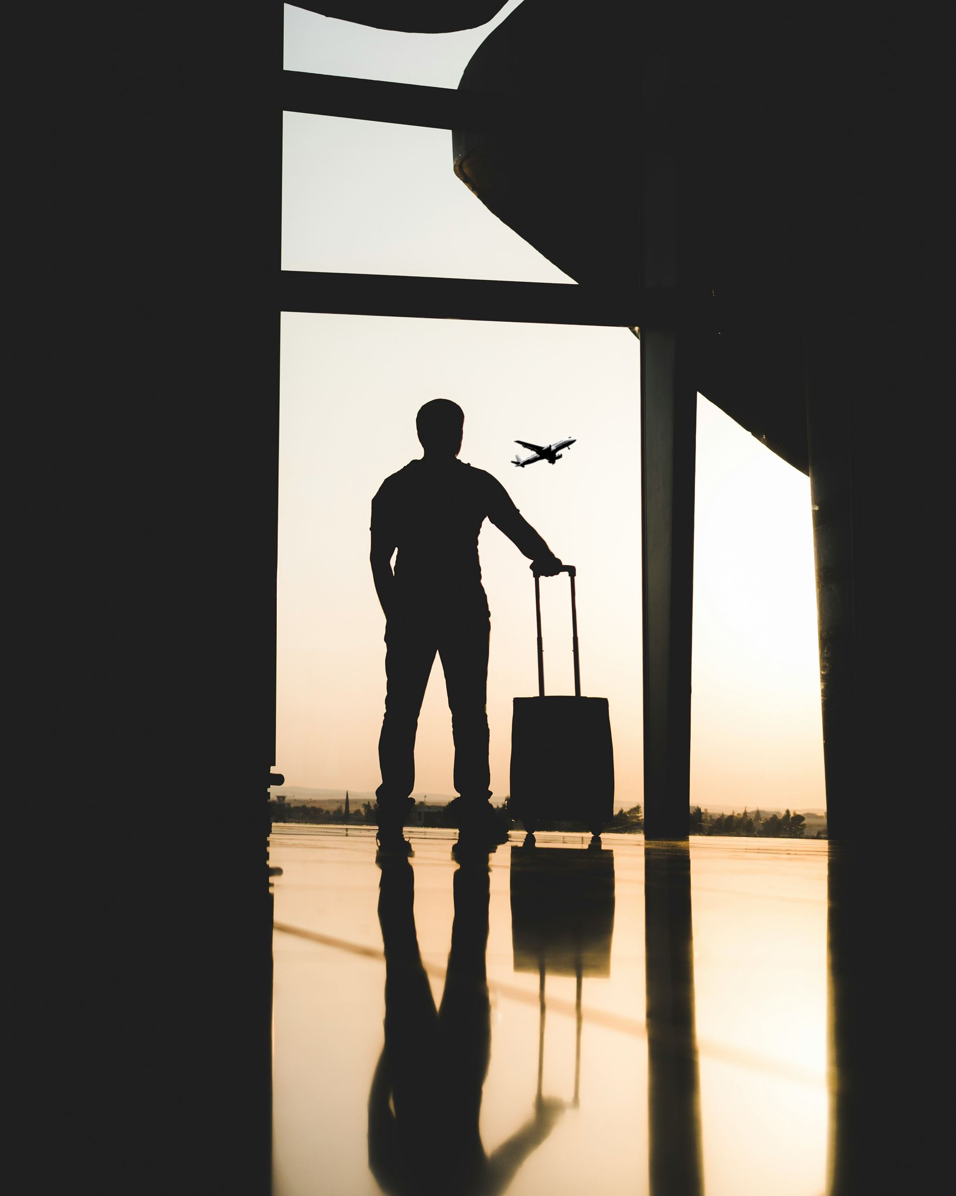 silhouette of man with suitcase